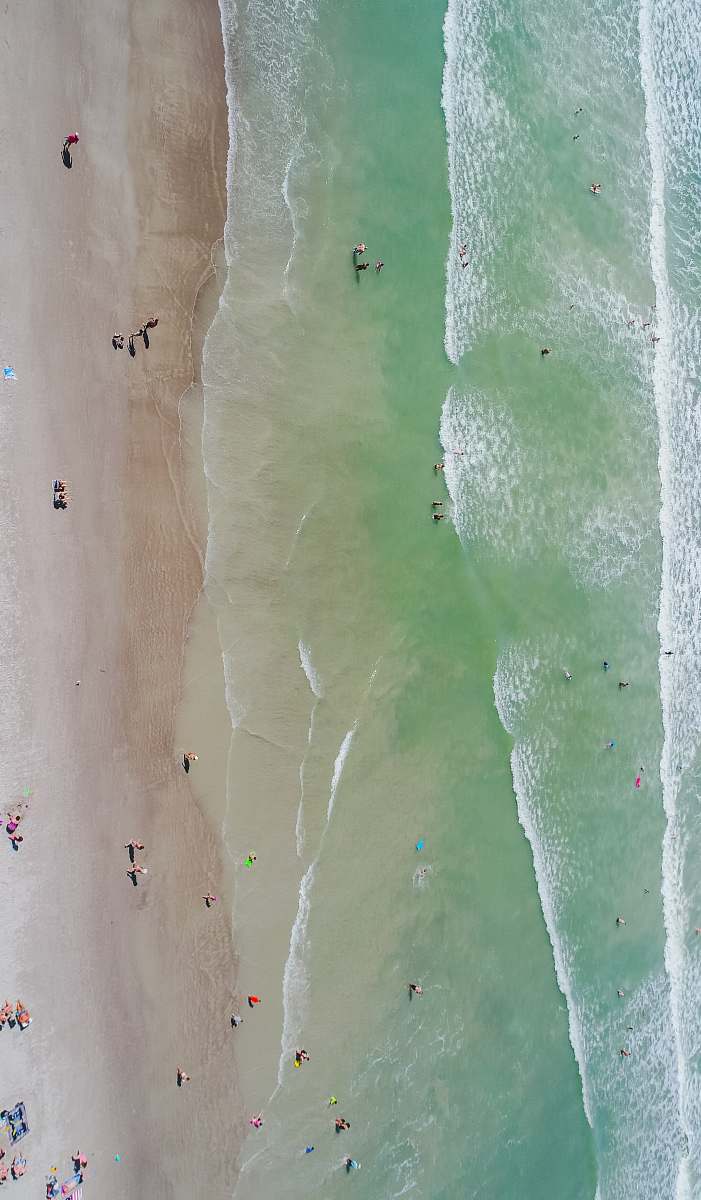 from above people at the beach during daytime aerial photography drone view